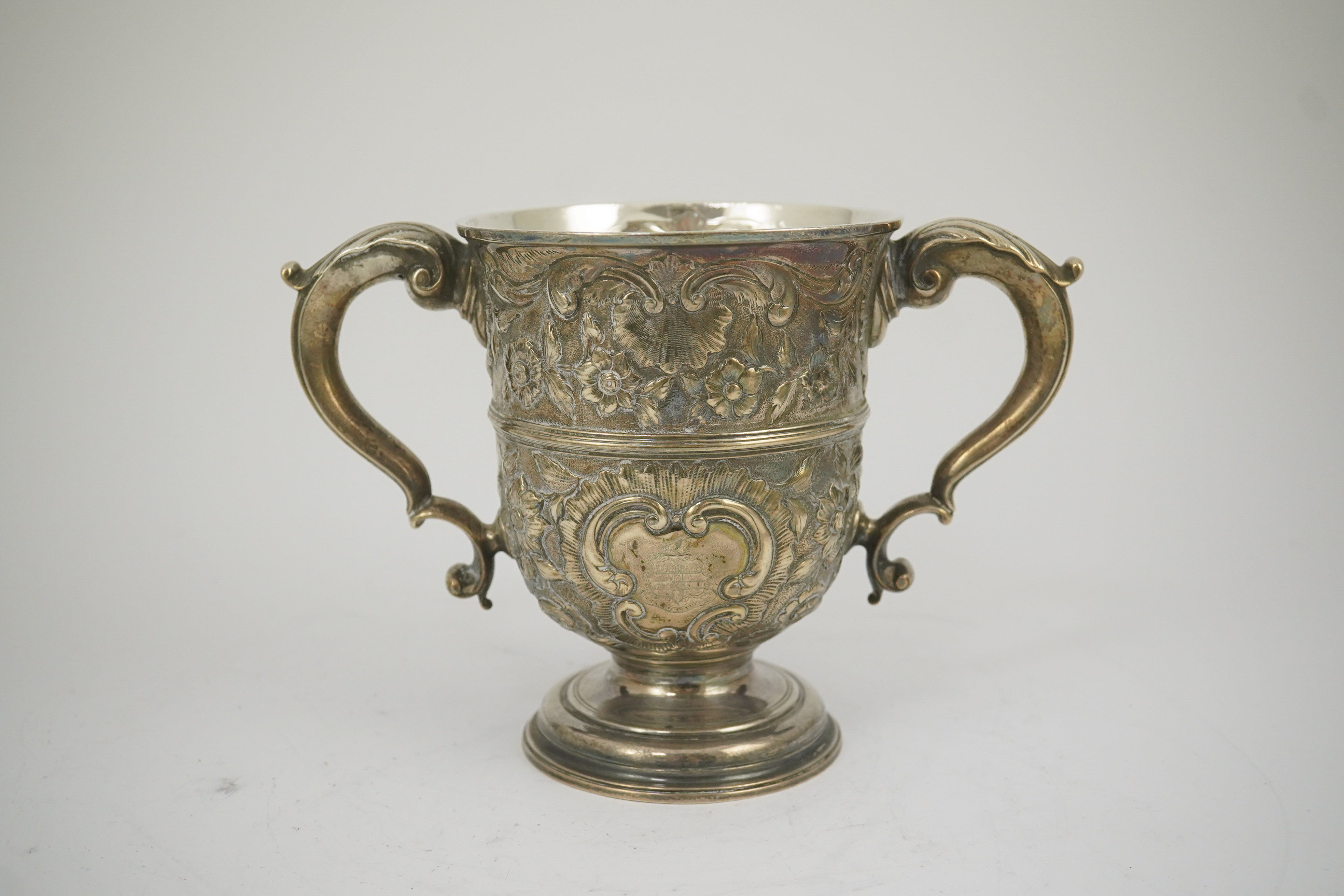 A George II silver loving cup with later floral embossed decoration, maker's initials RI, London, 1745